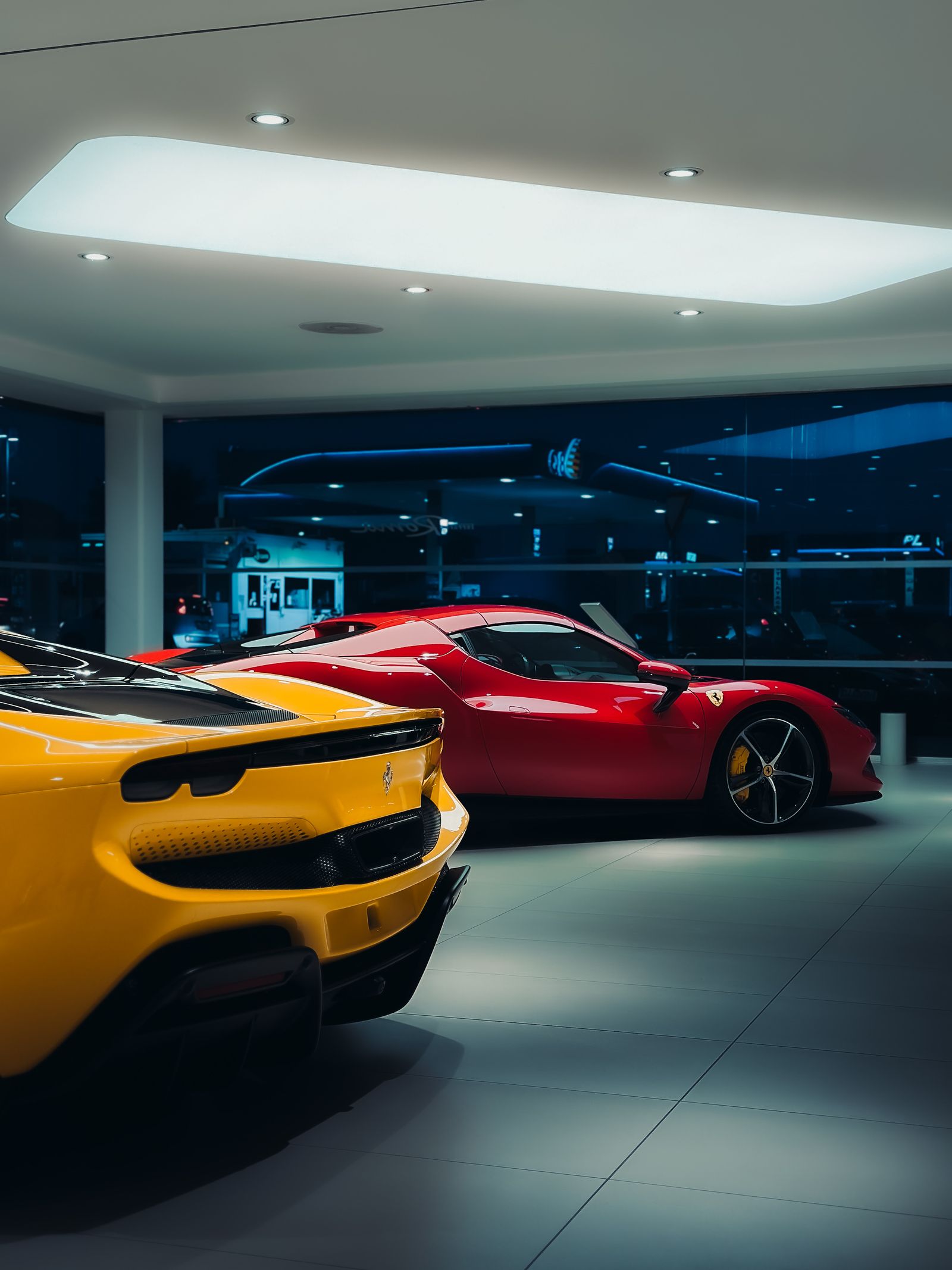 Showroom featuring luxury cars under soft lighting