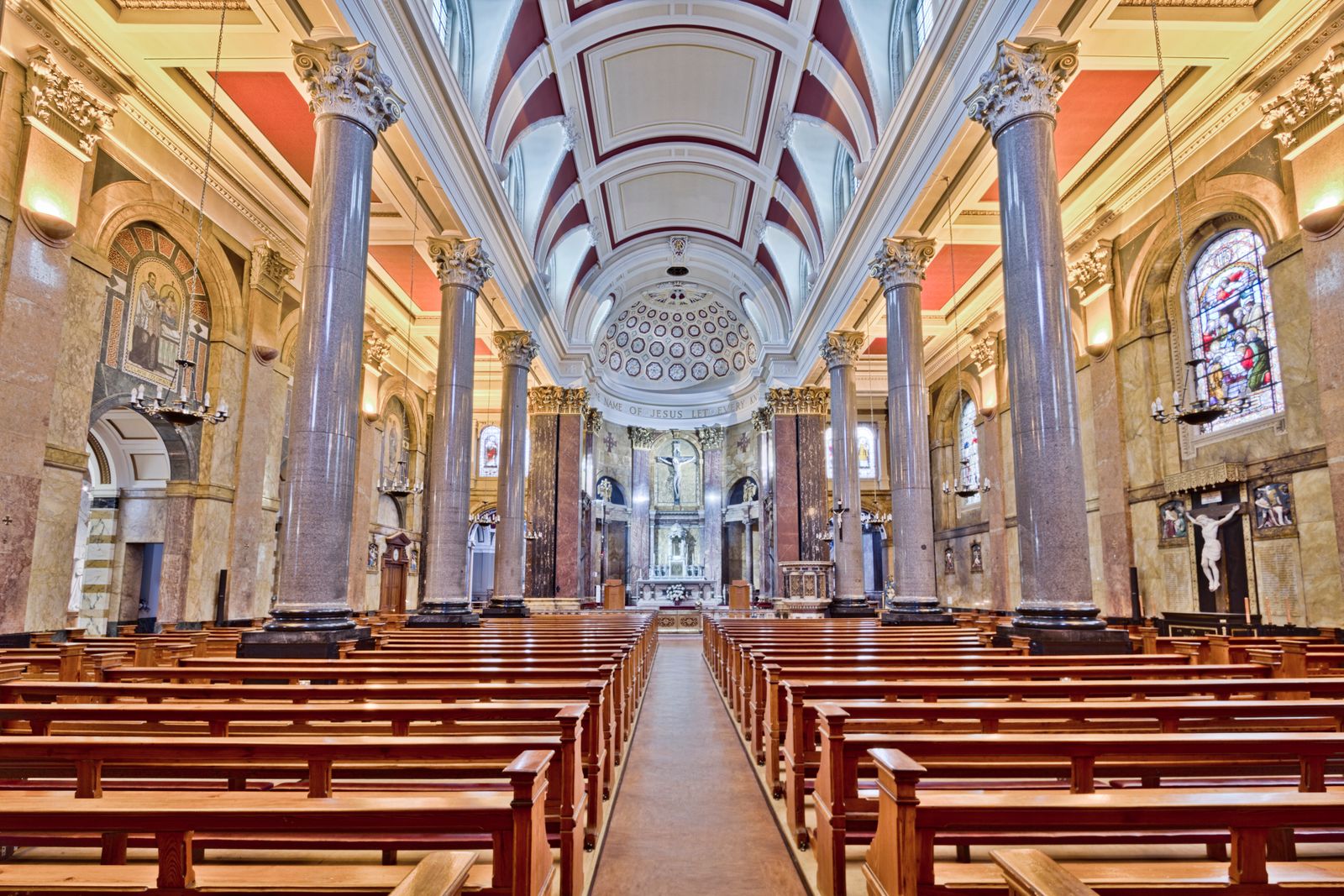 Bright historic church interior with grand pillars and stained glass windows