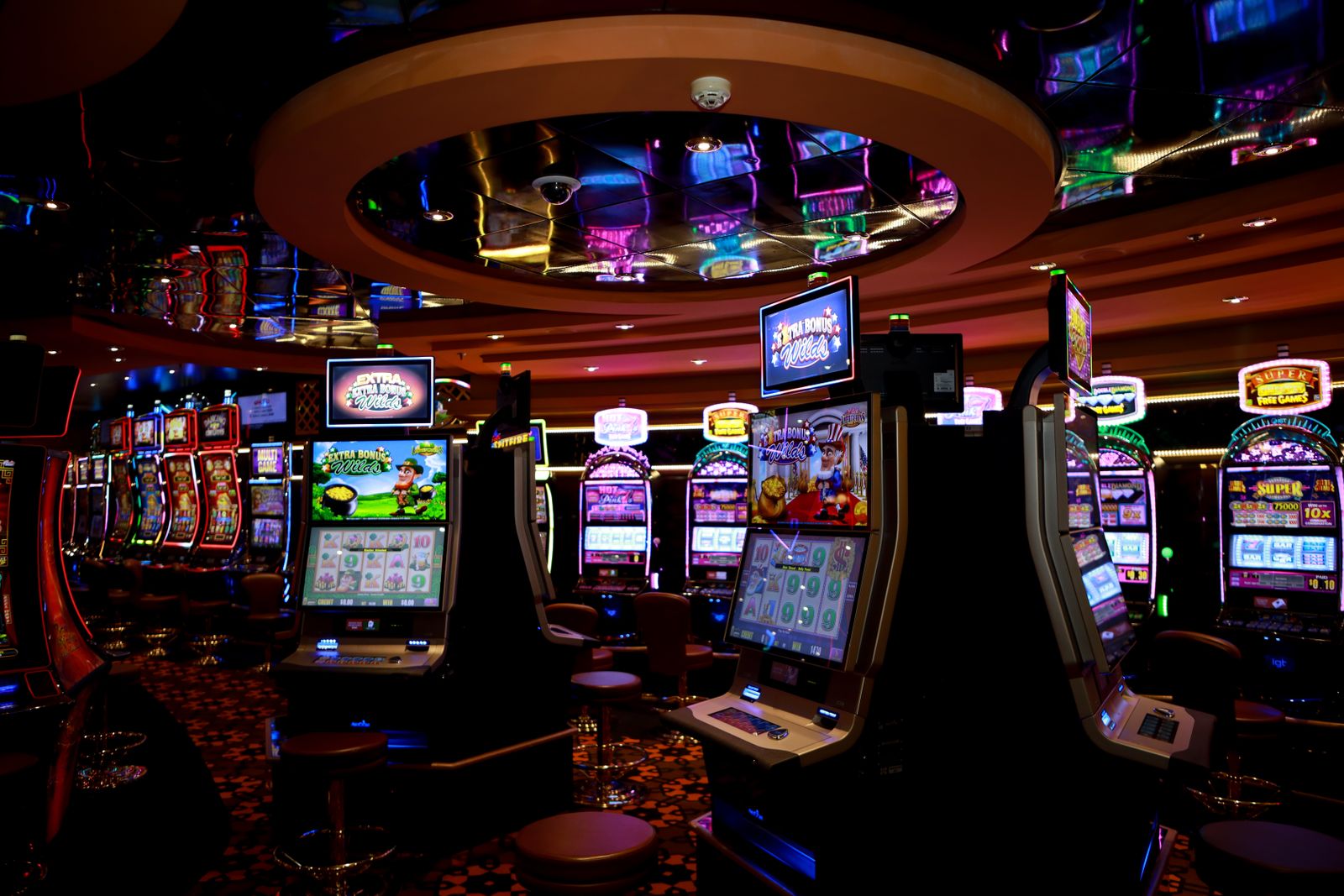 Vibrant casino floor with colorful slot machines and bright lights