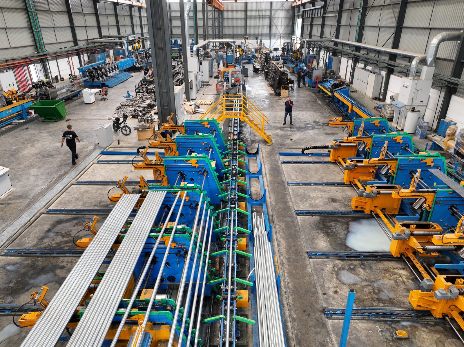 Aerial view of a large manufacturing plant interior with machinery and workers