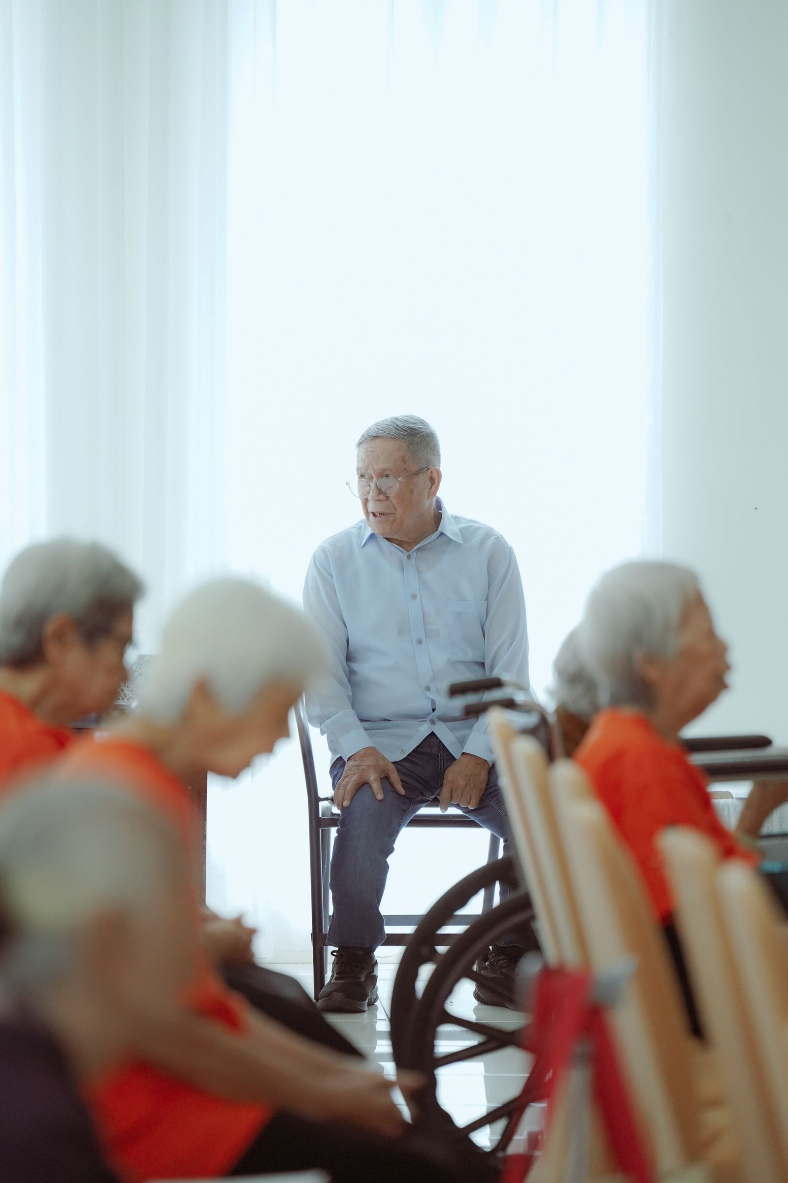 Group of seniors gathered together in a community meeting room